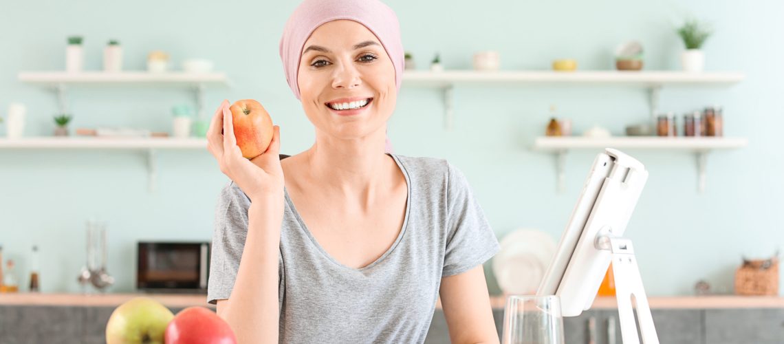 Woman after chemotherapy in kitchen at home