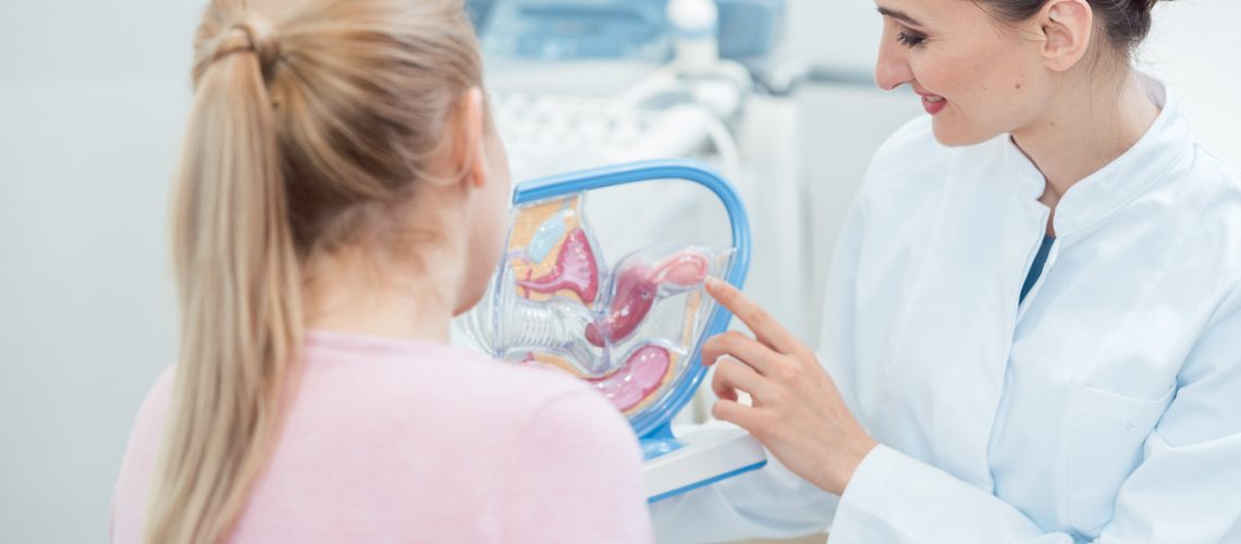 Childless woman in fertility clinic talking to doctor about issues having children